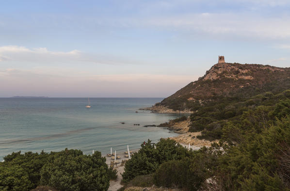 View of the turquoise sea and the stone tower overlooking the bay Porto Giunco Villasimius Cagliari Sardinia Italy Europe