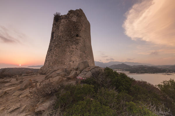 Sunset on the stone tower overlooking the bay Porto Giunco Villasimius Cagliari Sardinia Italy Europe
