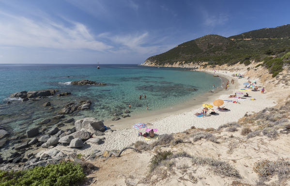 Tourists on the sandy beach of Porto Sa Ruxi surrounded by the turquoise sea Villasimius Cagliari Sardinia Italy Europ