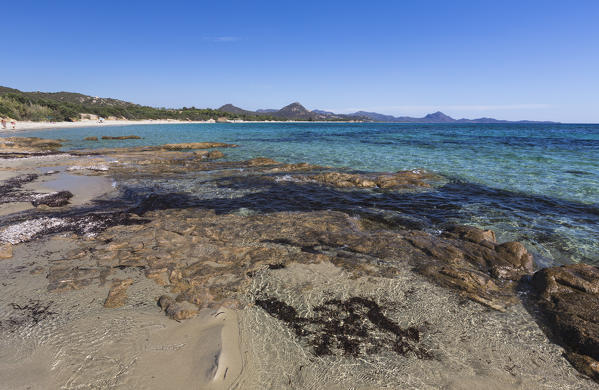 Rocks frame the turquoise water of sea around the sandy beach of Sant Elmo Castiadas Costa Rei Cagliari Sardinia Italy Europe