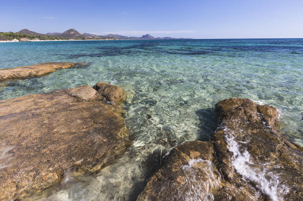 Rocks frame the turquoise water of sea around the sandy beach of Sant Elmo Castiadas Costa Rei Cagliari Sardinia Italy Europe