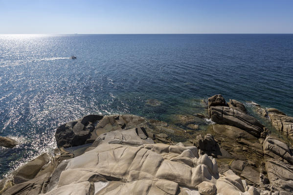 The sun shines on the white rocks eroded by wind framing the blue sea Punta Molentis Villasimius Cagliari Sardinia Italy Europe