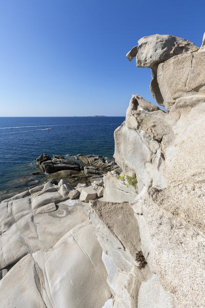 The sun shines on the white rocks eroded by wind framing the blue sea Punta Molentis Villasimius Cagliari Sardinia Italy Europe