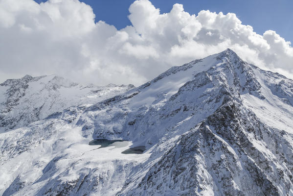 Aerial view of Peak Stella framed by snowy peaks and blue lakes Chiavenna Spluga Valley Valtellina Lombardy Italy Europe