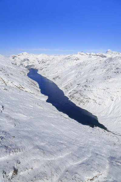 Aerial view of the alpine Lago di Lei surrounded by snow Val di Lei Chiavenna Spluga Valley Valtellina Lombardy Italy Europe
