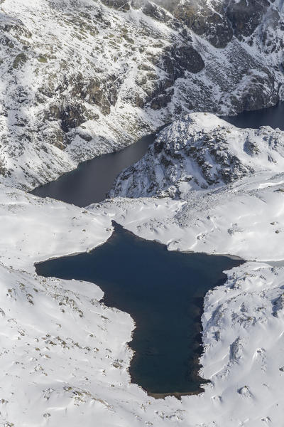 Aerial view of the blue Lake Croce framed by snowy peaks Spluga Valley Valtellina Lombardy Italy Europe
