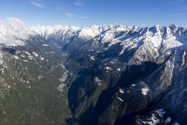 Aerial view of snowy peaks and green woods in a sunny autumn day Bregaglia Valley Switzerland Europe