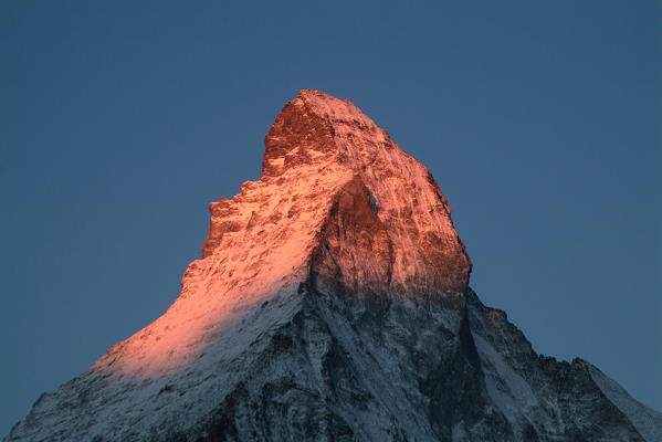 The wonderful pyramid of the snow-capped summit of the Matterhorn at sunrise, seen from the valley of Zermatt in the Canton of Valais in Switzerland Europe