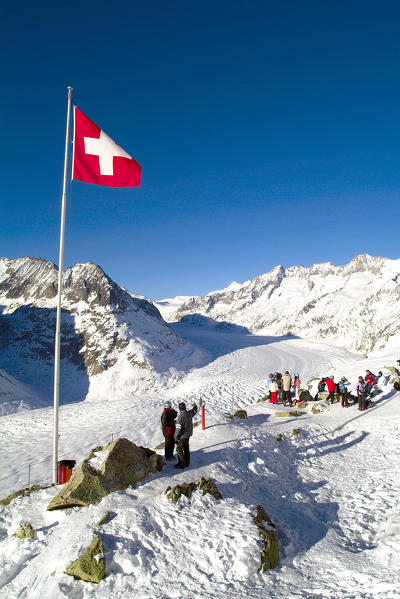 Tourists overlooking the Aletsch glacier from the top of the Bettmerhorn in the Swiss canton of Valais, Switzerland Europe