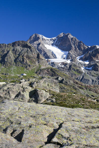 The majestic Pizzo Argent and Pizzo Zupo make the Bignami Hut appear so tiny. Valmalenco, Valtellina, Lombardy Italy Europe