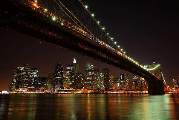 The Brooklyn Bridge at night and the skyline of New York USA