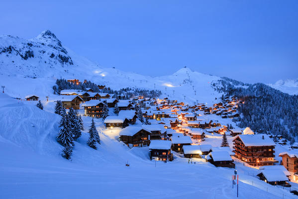 Blue dusk on the snowy alpine village surrounded by woods Bettmeralp district of Raron canton of Valais Switzerland Europe