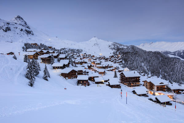Dusk lights on the snowy alpine village surrounded by woods Bettmeralp district of Radon canton of Valais Switzerland Europe