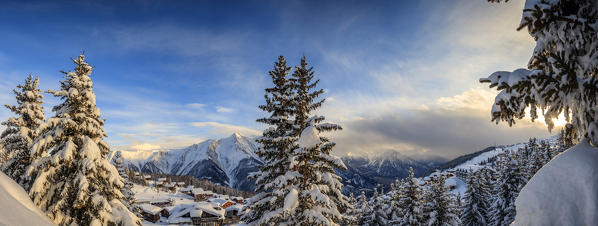 Panorama of snowy woods and mountain huts framed by sunset Bettmeralp district of Raron canton of Valais Switzerland Europe