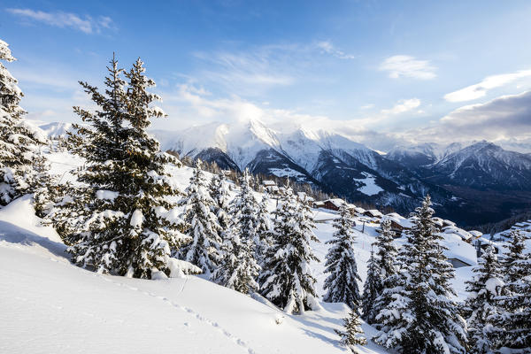 Snowy woods and mountain huts framed by the winter sunset Bettmeralp district of Raron canton of Valais Switzerland Europe