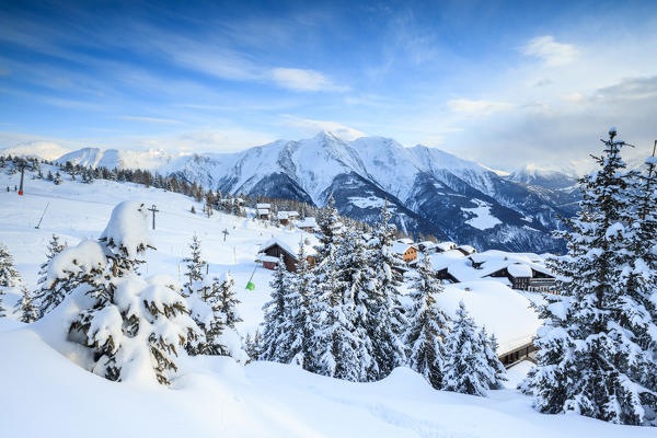 Snowy woods and mountain huts framed by the winter sunset Bettmeralp district of Raron canton of Valais Switzerland Europe