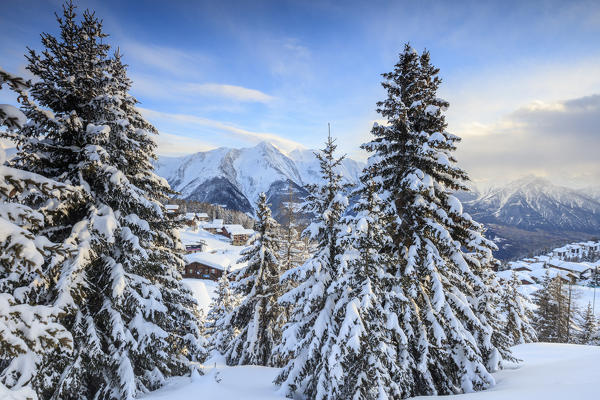 Snowy woods and mountain huts framed by the winter sunset Bettmeralp district of Raron canton of Valais Switzerland Europe