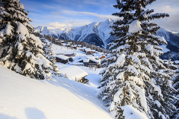 Snowy woods and mountain huts framed by the winter sunset Bettmeralp district of Raron canton of Valais Switzerland Europe