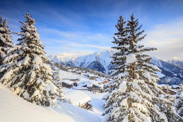 Snowy woods and mountain huts framed by the winter sunset Bettmeralp district of Raron canton of Valais Switzerland Europe