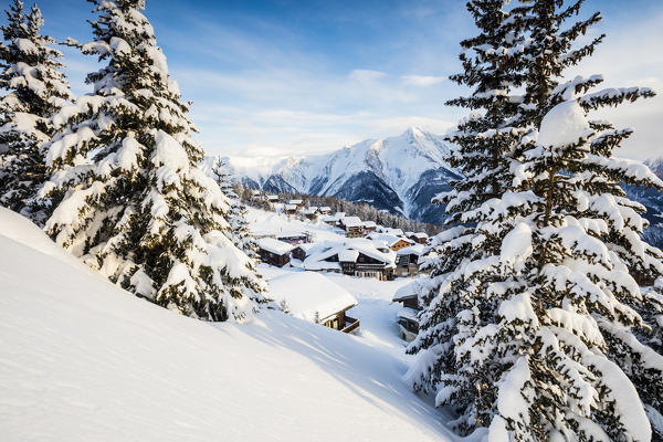 Snowy woods and mountain huts framed by the winter sunset Bettmeralp district of Raron canton of Valais Switzerland Europe