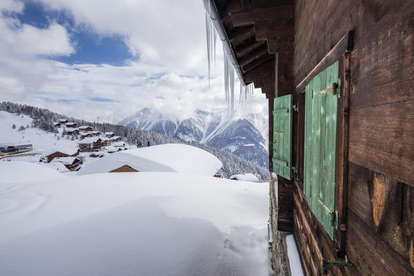Wooden hut frames the alpine village after a heavy snowfall Bettmeralp district of Raron canton of Valais Switzerland Europe