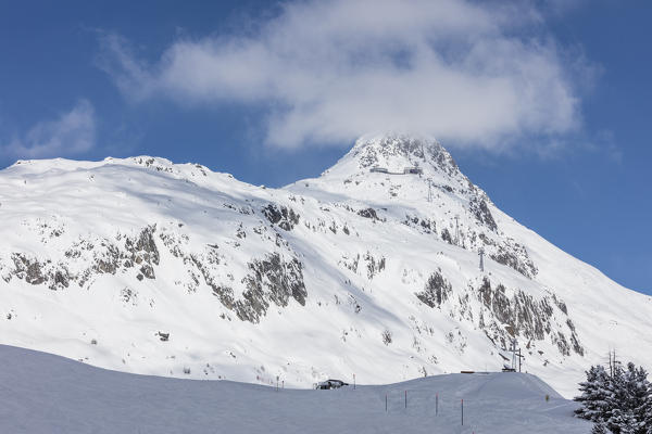 Blue sky frames the snowy peak and ski slopes on a sunny day Bettmeralp district of Raron canton of Valais Switzerland Europe