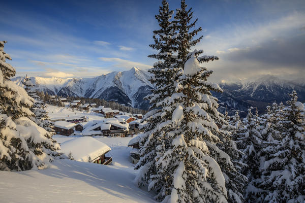 Sunset frames the mountain huts and woods covered with snow Bettmeralp district of Raron canton of Valais Switzerland Europe