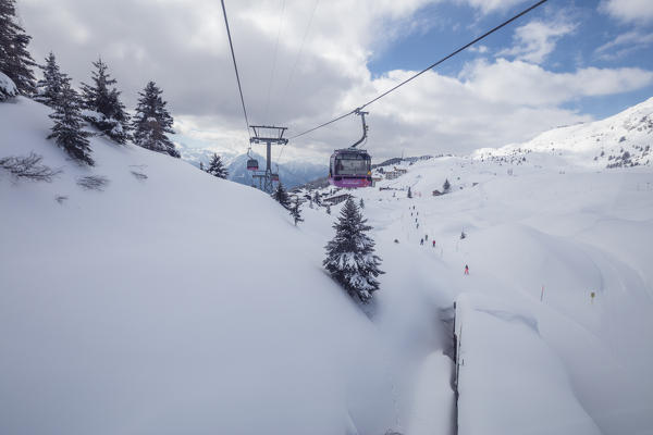 Cableways on the ski slopes surrounded by snowy woods Bettmeralp district of Raron canton of Valais Switzerland Europe