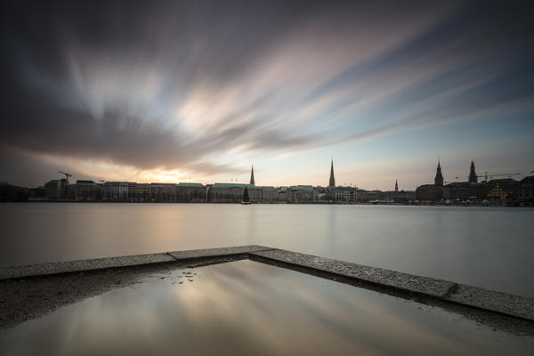 Clouds and lights of twilight on Inner Alster Lake with the Christmas Tree suspended in its water Hamburg Germany Europe