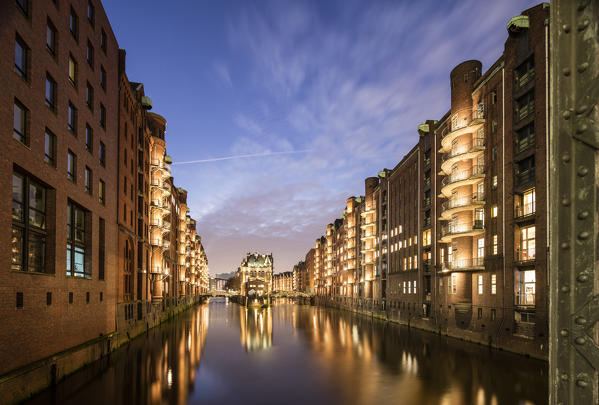 The water castle and buildings are reflected in the canal at dusk Poggenmühlenbrücke Altstadt Hamburg Germany Europe