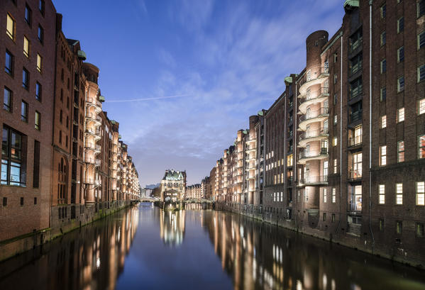 The water castle and buildings are reflected in the canal at dusk Poggenmühlenbrücke Altstadt Hamburg Germany Europe