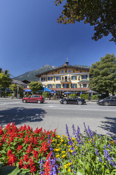 The typical hotels surrounded by peaks and colorful flowers Garmisch Partenkirchen Oberbayern region Bavaria Germany Europe