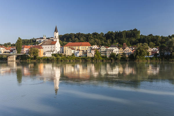 View of the bell tower and typical houses reflected in the river Passau Lower Bavaria Germany Europe