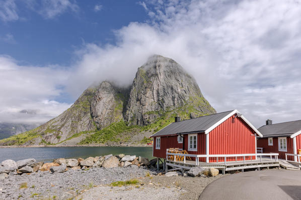 Typical houses of fishermen called Rorbu framed by peaks Hamnøy Moskenes Nordland county Lofoten Islands Northern Norway Europe