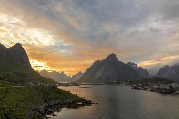 Sunset on the fishing village surrounded by rocky peaks and sea Reine Nordland county Lofoten Islands Northern Norway Europe