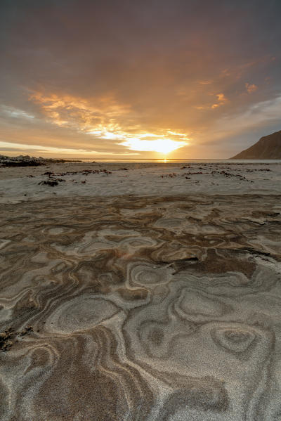 The midnight sun is reflected on the sandy beach of Skagsanden Ramberg Nordland county Lofoten Islands Northern Norway Europe