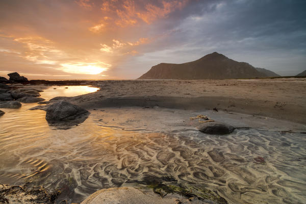 The midnight sun is reflected on the sandy beach of Skagsanden Ramberg Nordland county Lofoten Islands Northern Norway Europe