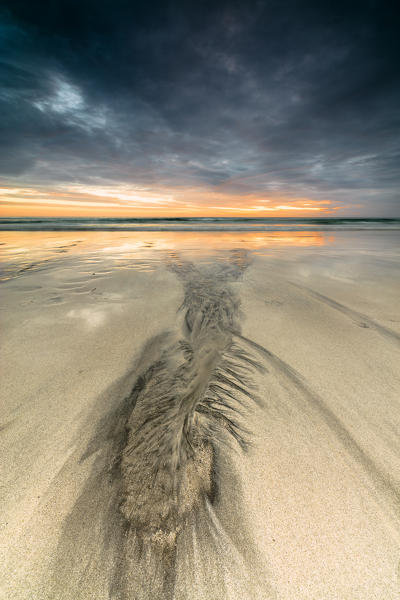 Midnight sun and clouds frame the sandy beach of Skagsanden Ramberg Nordland county Lofoten Islands Northern Norway Europe