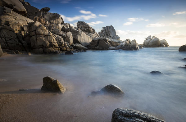Waves crashing on the sandy beach framed by cliffs Capo Testa Santa Teresa di Gallura Province of Sassari Sardinia Italy Europe