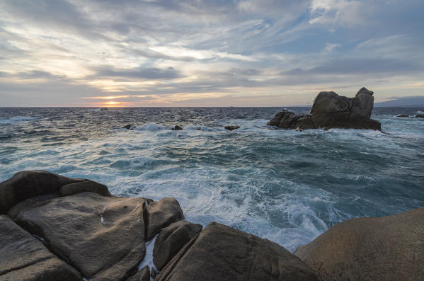 The light of sunset over the blue sea framed by cliffs Capo Testa Santa Teresa di Gallura Sassari Province Sardinia Italy Europe