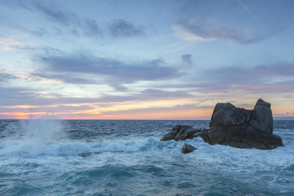 Dusk on the waves of blue sea crashing on rocks Capo Testa Santa Teresa di Gallura Province of Sassari Sardinia Italy Europe