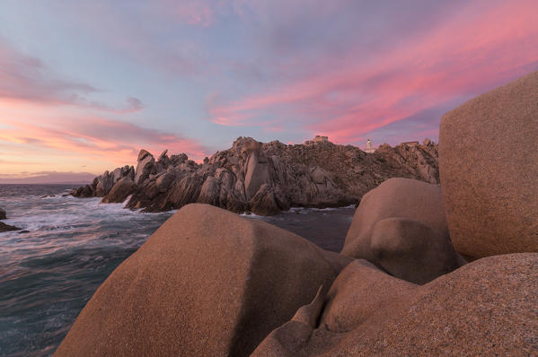 Pink sky at sunset frames the lighthouse on cliffs Capo Testa Santa Teresa di Gallura Province of Sassari Sardinia Italy Europe