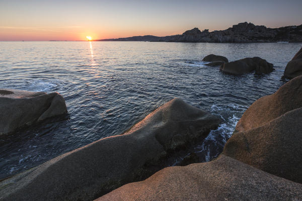 Sunset on modeled cliffs by wind framing blue sea Capo Testa Santa Teresa di Gallura Province of Sassari Sardinia Italy Europe