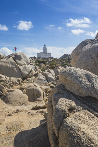 Child on the granitic rocks admires the lighthouse Capo Testa Santa Teresa di Gallura Province of Sassari Sardinia Italy Europe