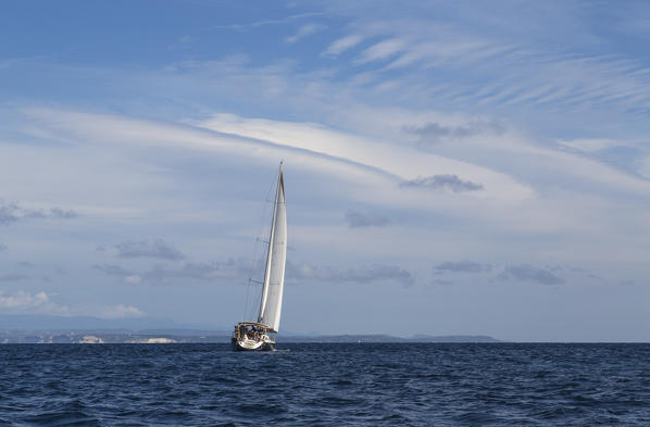 Sail boat in the clear sea under a blue summer sky Capo Testa Santa Teresa di Gallura Province of Sassari Sardinia Italy Europe