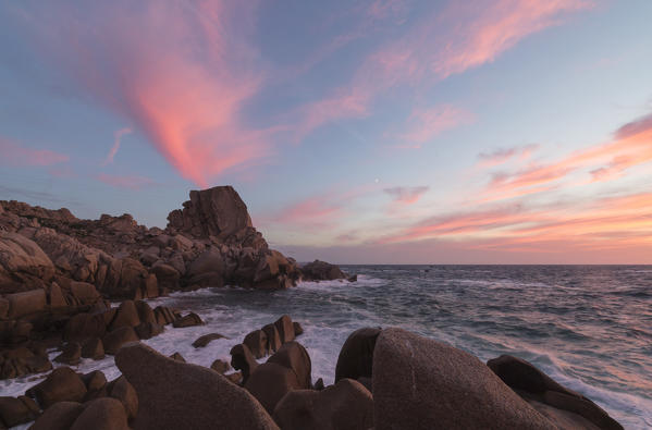 Pink sky at sunset on the waves crashing on cliffs Capo Testa Santa Teresa di Gallura Province of Sassari Sardinia Italy Europe