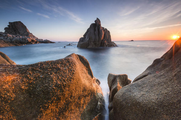 The light of sunset on blue sea framed by cliffs Capo Testa Santa Teresa di Gallura Province of Sassari Sardinia Italy Europe