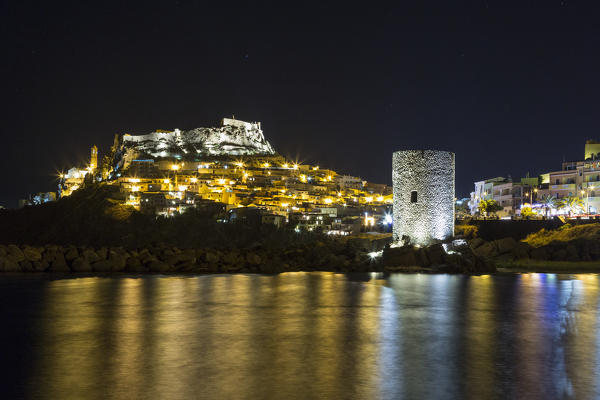 Night view of village on promontory and its medieval tower Castelsardo Gulf of Asinara Province of Sassari Sardinia Italy Europe