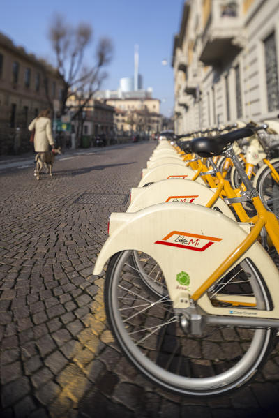 Yellow city bikes sharing and in the old town center of Milan Lombardy Italy Europe