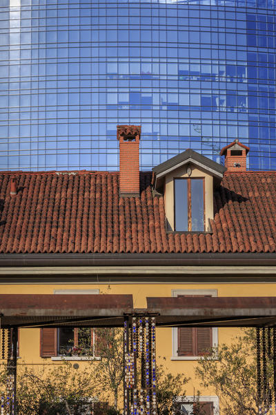 The contrast between old typical houses and new modern buildings and skyscrapers Milan Lombardy Italy Europe